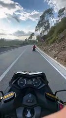 Motorcycle Follows Wheelchair Down Hill