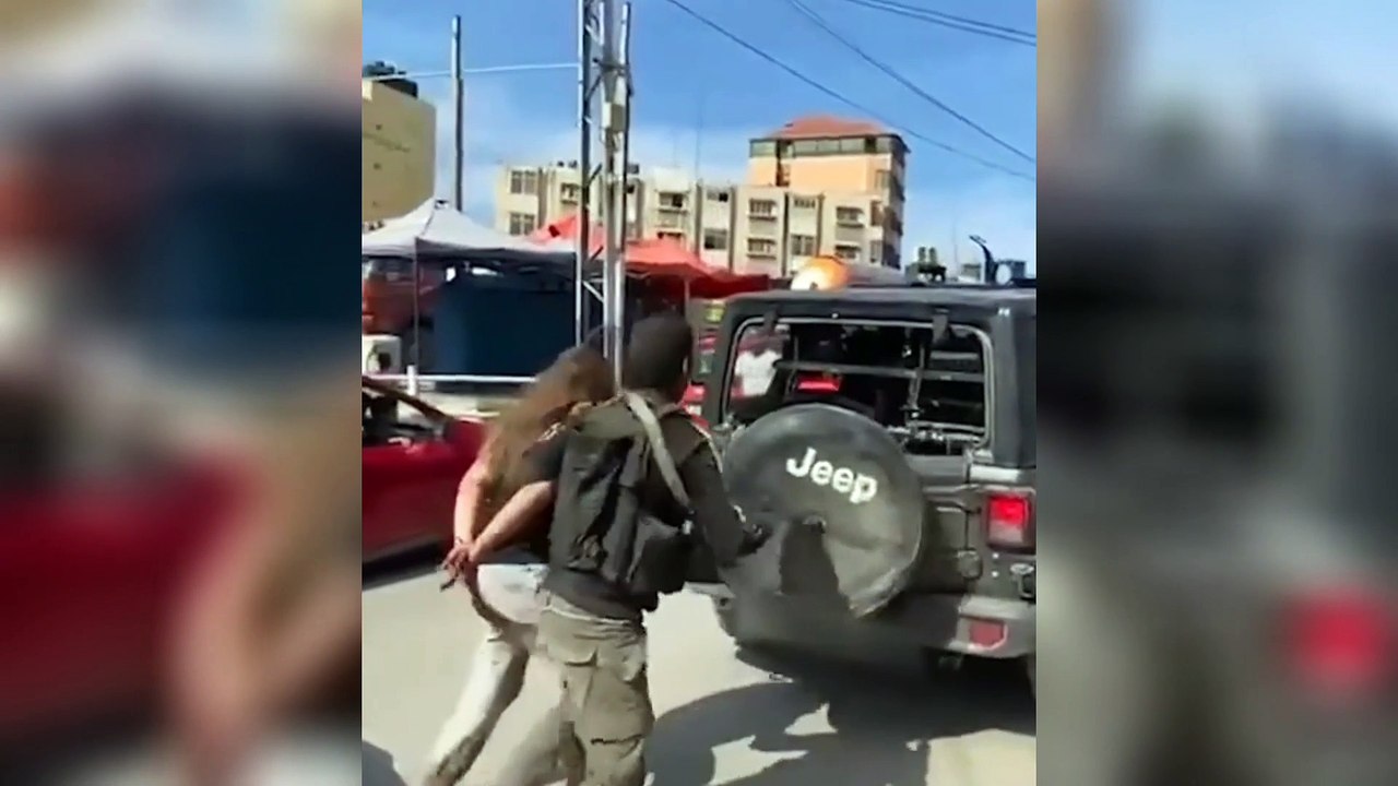 A video appears to show Palestinian militants taking an Israeli woman hostage, hours after Hamas launched a deadly land, air and sea attack and fired a barrage of rockets at Israel.