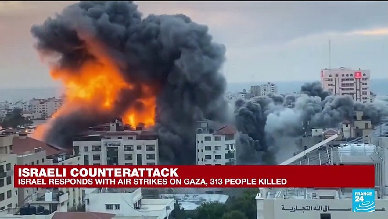 Gazans walk through rubble of their homes after...
