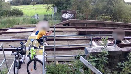 Couple pose on railway track for a picture where trains speed by at 100mph
