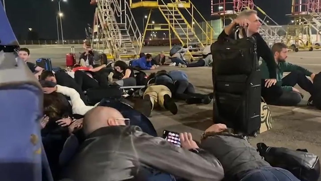 Plane passengers duck for cover at Tel Aviv airport as missile sirens echo
