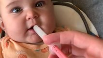 Precious baby needs NO WORDS to express her dislike for toothache medicine