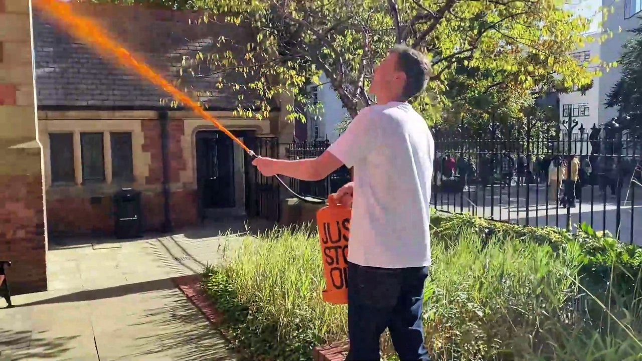 Watch as a Just Stop Oil supporter sprays a University of Leeds building with orange paint