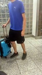 Baby Rides Through Airport Strapped To Carry-On Suitcase