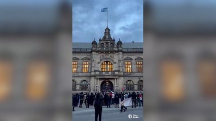 Pro-Palestine protesters scale town hall to tear down Israeli flag