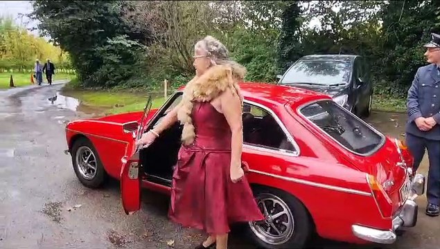 Wedding vow renewal guests travel by vintage red bus for pictures with Just Jane Lancaster