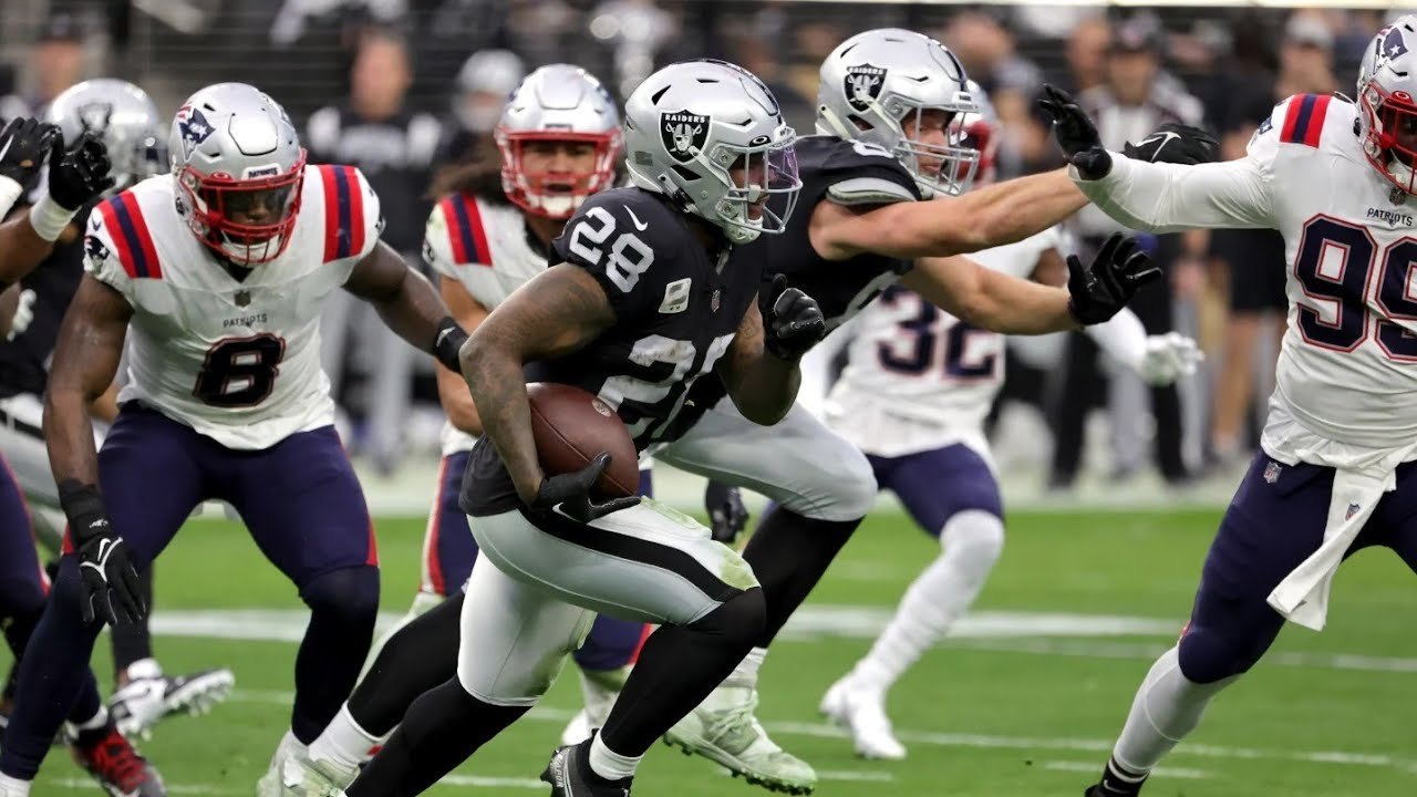 Raiders' Jimmy Garoppolo (back) leaves victory over Patriots