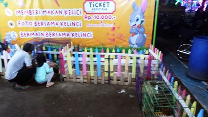 feeding rabbit at the night market