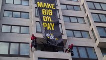 Climate activists abseil down luxury London hotel to unfurl oil protest banner