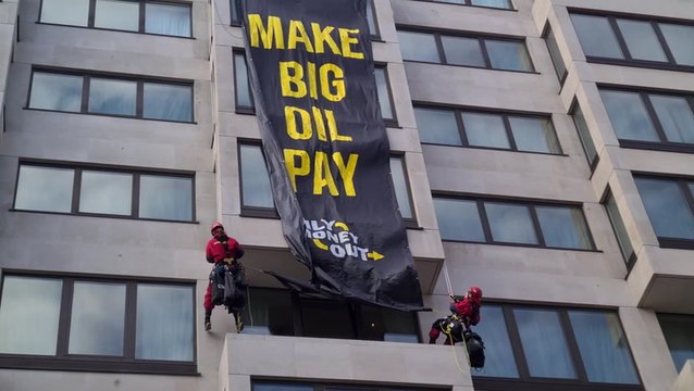 Climate activists abseil down luxury London hotel to unfurl oil protest banner