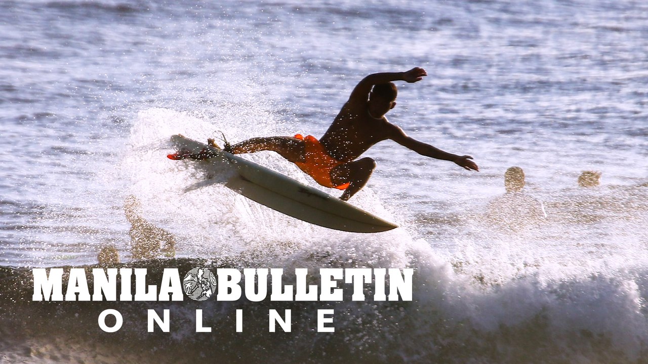 Surfers practice on Cloud 9 Beach in Siargao Is...
