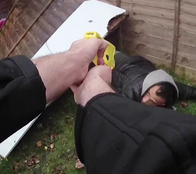 One of the UK's 'most wanted burglars' found hiding under fence