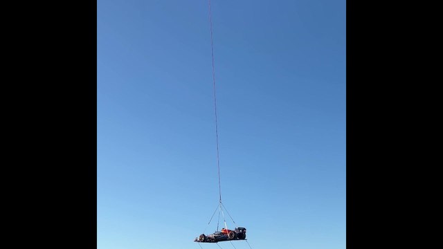 Red Bull reveals Texas-inspired livery for US GP flying car over Austin attached to a helicopter