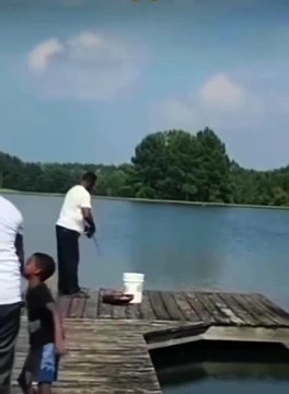 Boy pushes his father on crutches into lake