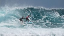 Surfer Playfully Pushes Another Surfer While Riding on Wave
