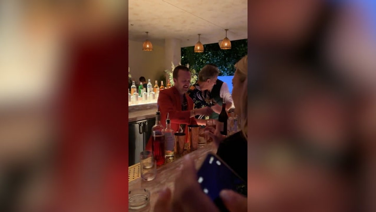 Bryan Cranston and Aaron Paul bartend at Drake’s birthday party
