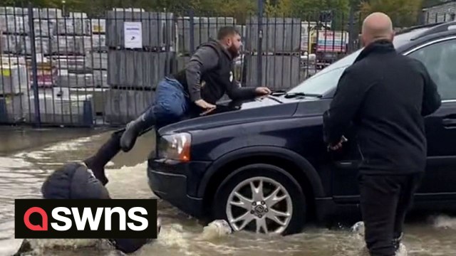 Motorist drives into man in flood water - carrying him on bonnet - before knocking over woman