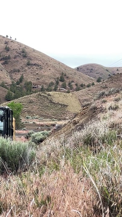 Construction Workers Demolish A Hilltop