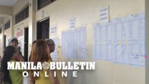 Malabon voters check their names and corresponding precincts before voting