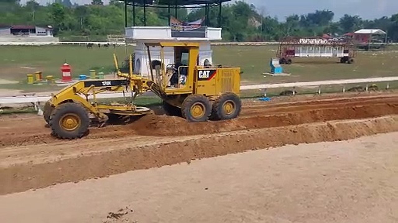 Motor grader working on a horse racing track improvement project ...