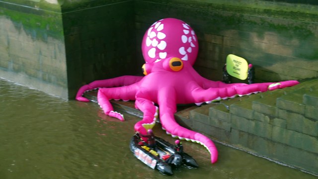 Greenpeace activists unfurl a giant octopus in the Thames