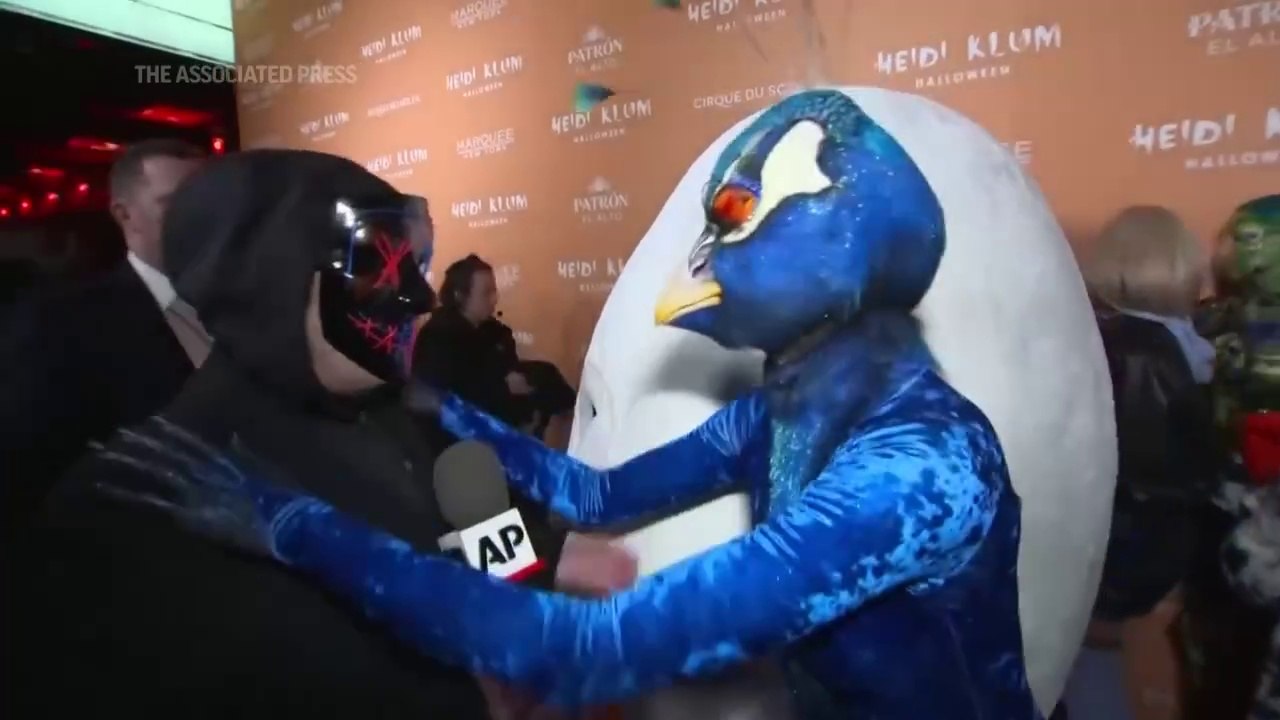 Heidi Klum arrives at her annual Halloween party dressed as a peacock