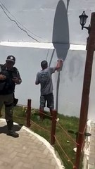 Jovem é 'incentivado' por militares a pintar muro de praça que pichou
