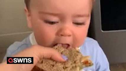 Adorable baby gets frustrated as he is unable to take a bite from his mum’s sandwich