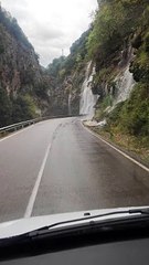 Heavy Rain Creates a Waterfall Over Road