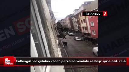 Sultangazi'de çatıdan kopan parça balkondaki çamaşır ipine asılı kaldı