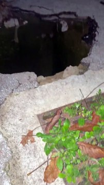 Car Drives Over Large Hole In Ground