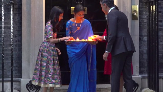 Rishi Sunak and his family light candles outside Downing Street for Diwali
