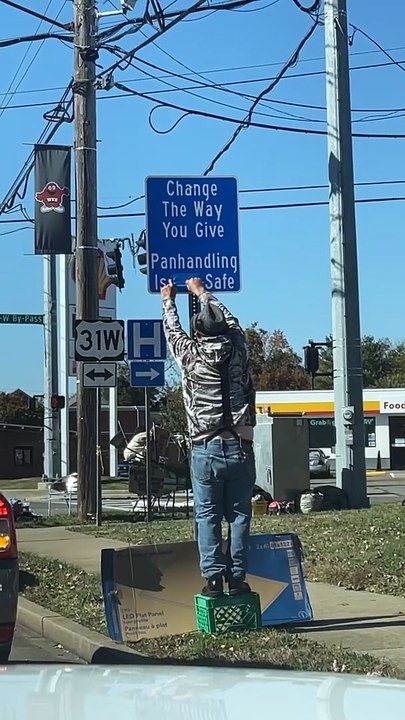 Panhandler Corrects Sign In Front Of Police