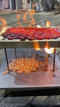 Dripping Molten Glass Over a Wooden Board With Holes
