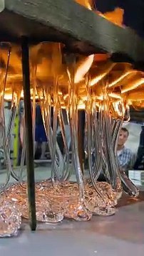 Dripping Molten Glass Over a Wooden Board With Holes