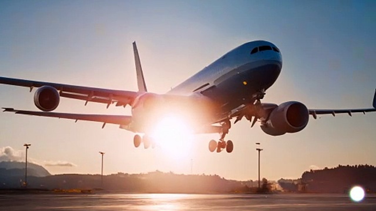 An airplane is flying in the blue sky with clouds all around