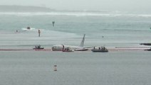 US military jet overshoots runway and crash lands in ocean off Hawaii