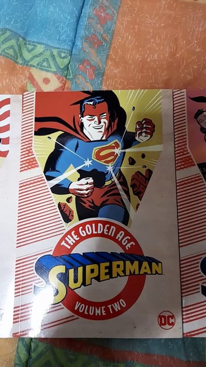 An experimental video featuring 4 Golden Age Superman trades and 2 Silver Age Supergirl trades
