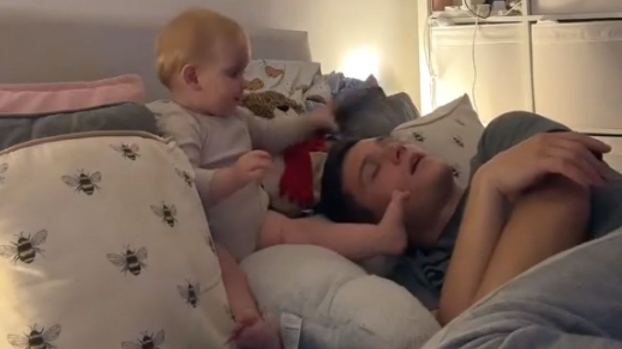 'She got me good!' - Mischievous baby gets dad's head in the right place when she sees him sleeping