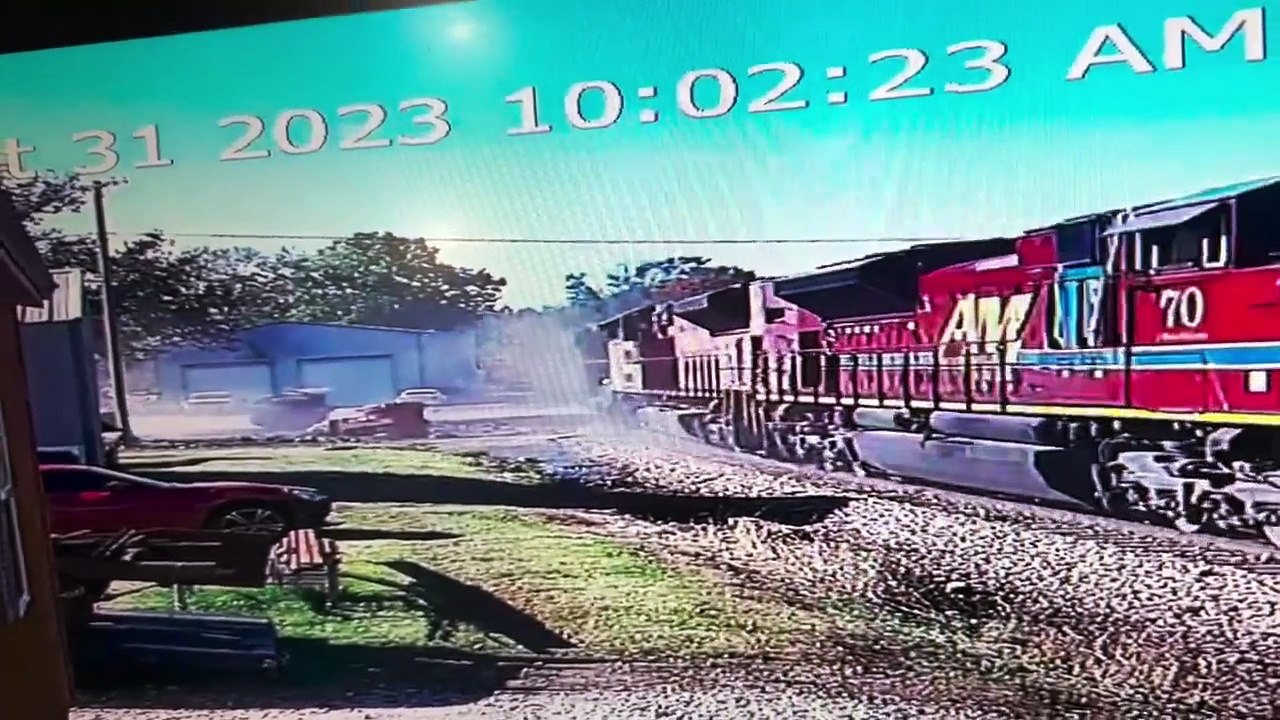 A Trailer And Train Meet On The Tracks
