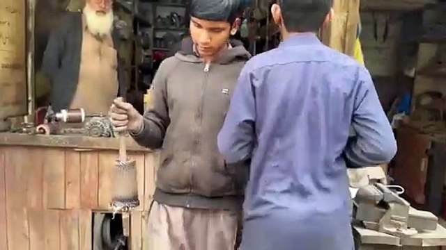 Skillful Young Guy Rewinding Process Of Caterpillar Starter Motor-Rebuilding Starter Motor Armature
