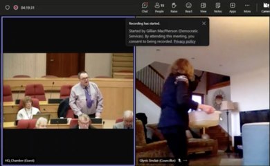 Highland Councillor cleans her windows during online meeting