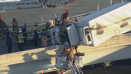 Moment driver rescued from truck hanging off Houston overpass
