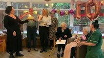 Edith Laycock opens her letter from the King at her 107th birthday party