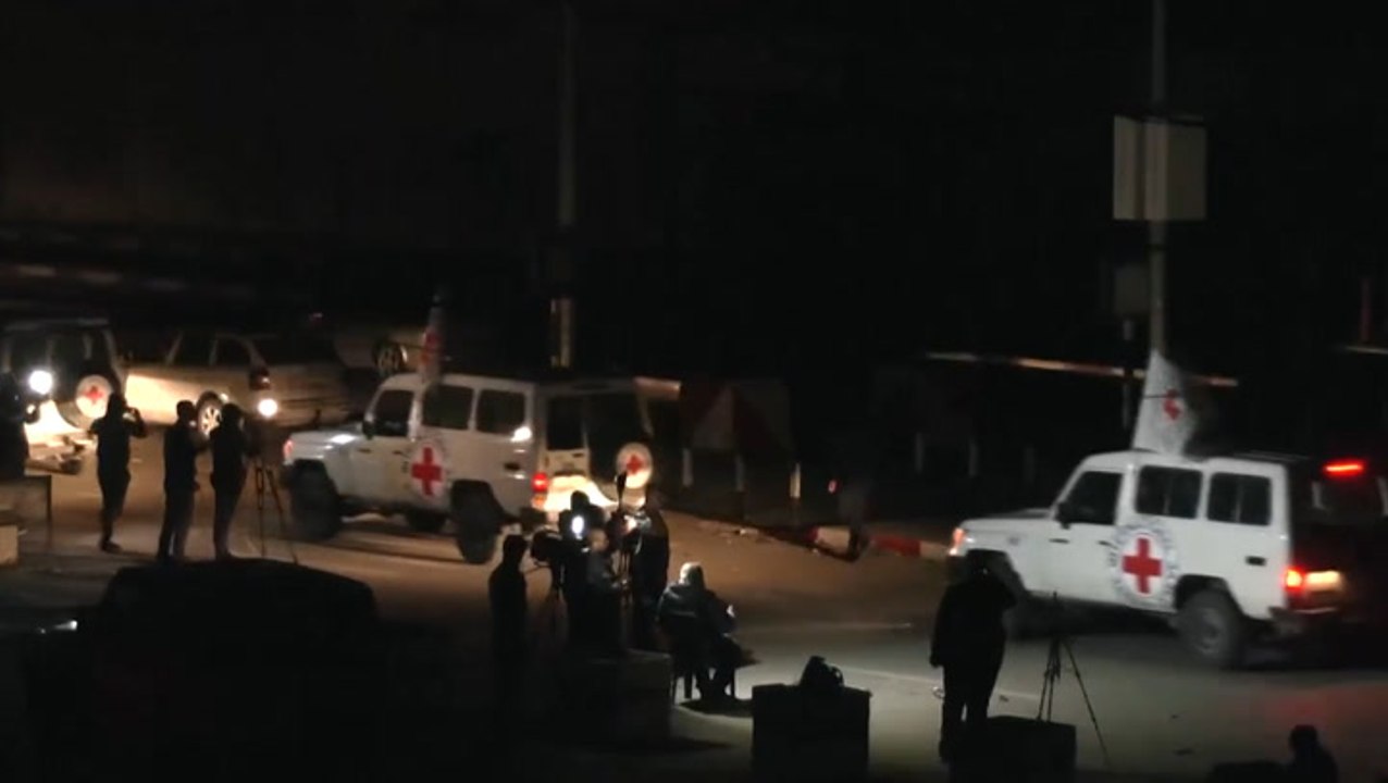 Moment Red Cross convoy carrying released hostages held by Hamas crosses from Gaza towards Israel