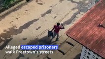 Alleged escaped prisoners walk in streets of Sierra Leone's Freetown