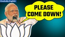 Telangana polls: PM Modi requests supporter to climb down tower during a rally | Oneindia News