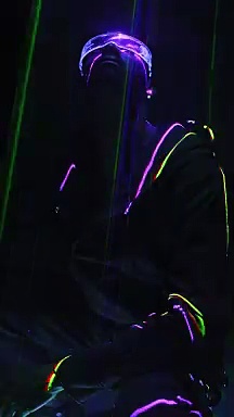 mixkit-a-man-sitting-beneath-laser-lights-in-cyberpunk-glasses-50461-medium.mp4