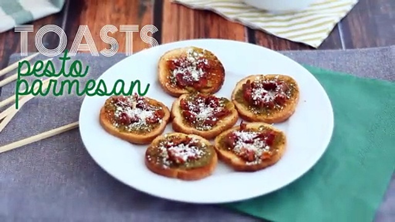 Toasts with pesto, parmesan, and sun-dried tomatoes