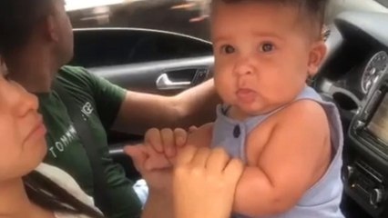 Silly baby boy humors his family by rapidly switching between sad & happy faces